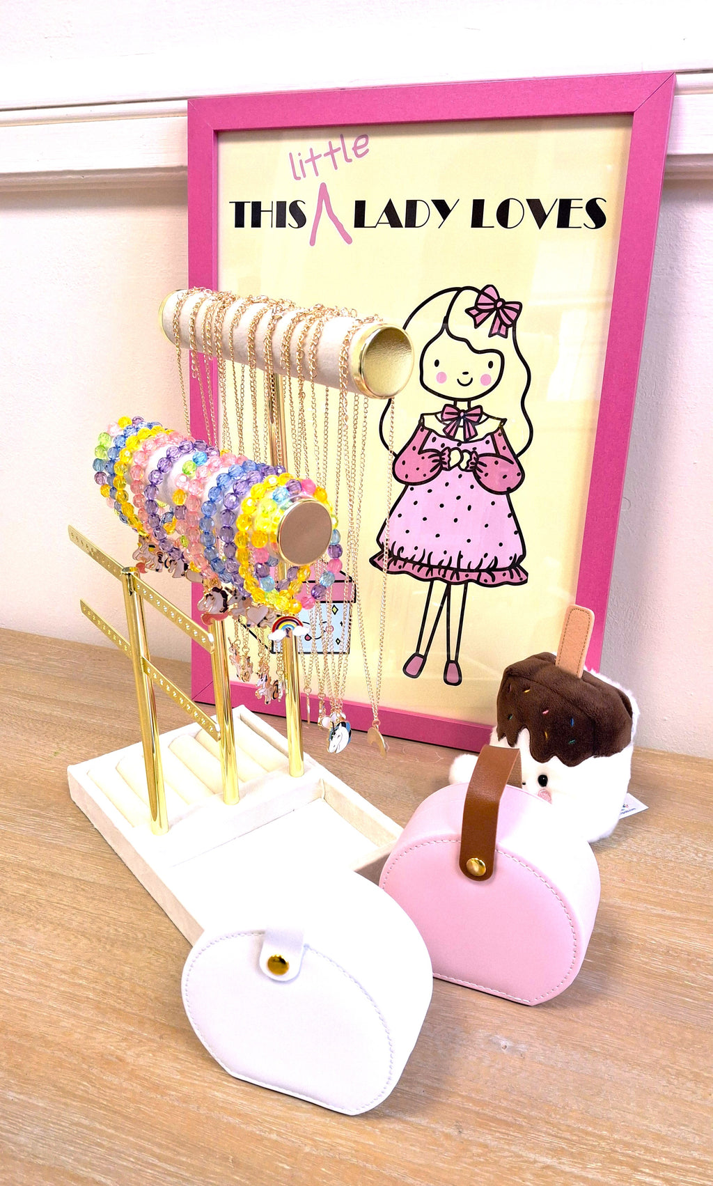 An example of necklace and bracelet jewellery, including white and pink jewellery boxes.