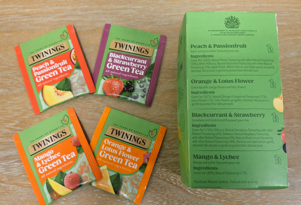 A photo of Twinings Fruit and Green Tea tea sachets and ingredients. 