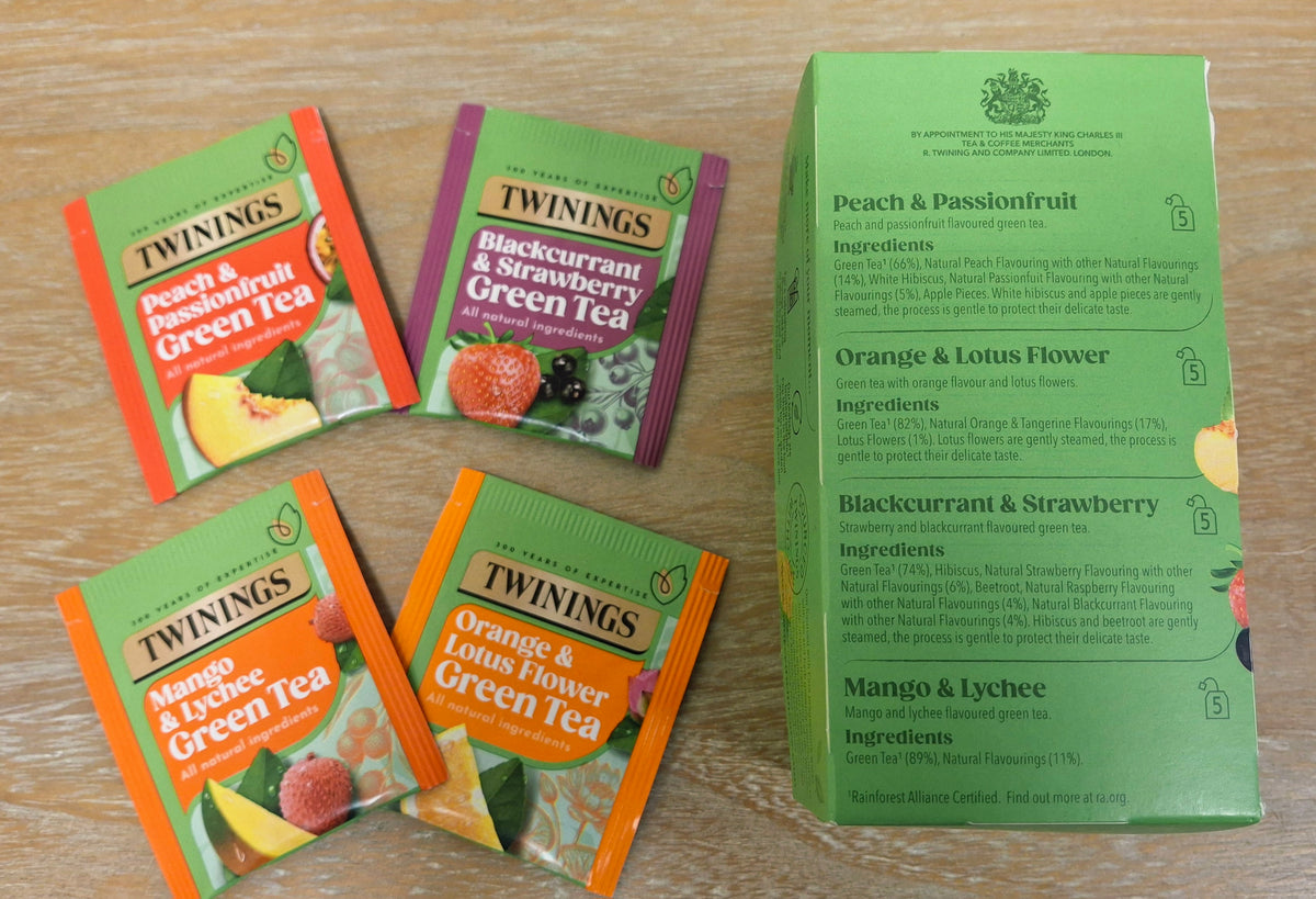 A photo of Twinings Fruit and Green Tea tea sachets and ingredients. 
