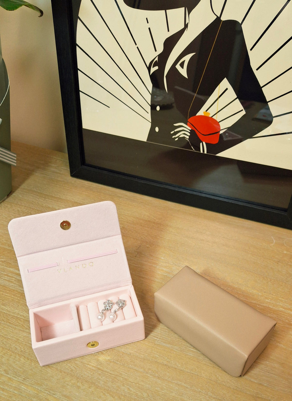 Travel jewellery box with a pair of drop earrings.
