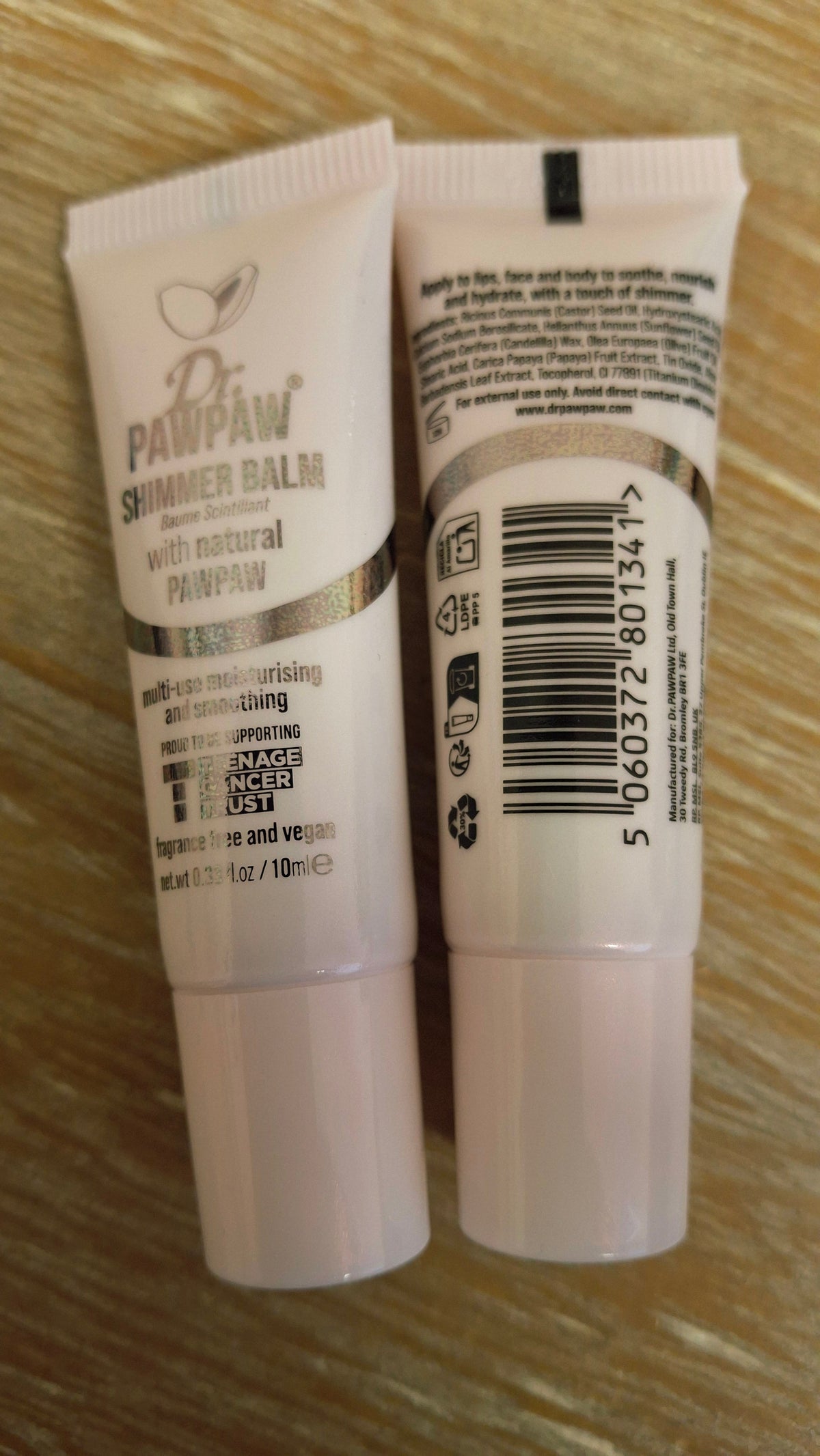 Two white tubes of Dr. PAWPAW Shimmer Balm with natural PAWPAW, one showing the front label and the other showing the ingredients.
