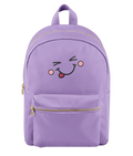 A light purple nylon backpack with a gold zipper, featuring an embroidered winking face with a pink tongue on the front pocket.