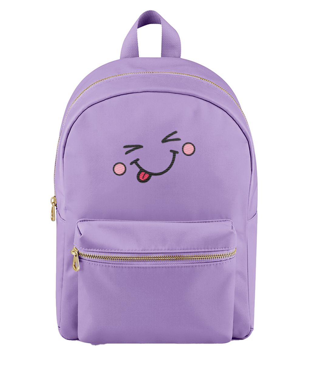 A light purple nylon backpack with a gold zipper, featuring an embroidered winking face with a pink tongue on the front pocket.