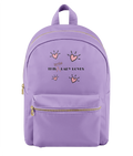 A lavender purple backpack with gold zippers and a front pocket, featuring a graphic print of pink hearts and the text 'This Little Lady Loves' on the front.