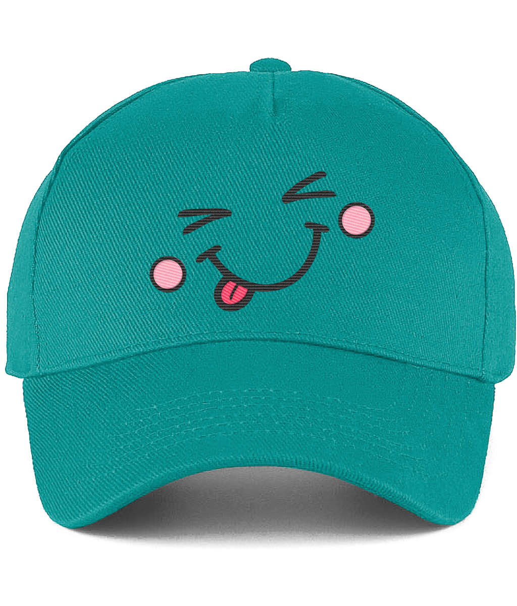 A teal green baseball cap featuring a playful embroidered face on the front with closed eyes, pink cheeks, and a pink tongue sticking out, shown against a plain white background.