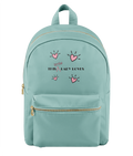 A mint green backpack with a front pocket, gold-tone zippers, and a graphic print featuring pink hearts and the text 'This Little Lady Loves' on the front, set against a plain white background.