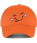 An orange baseball cap featuring a cartoon embroidered face on the front with winking eyes, pink cheeks, and a sticking-out tongue.