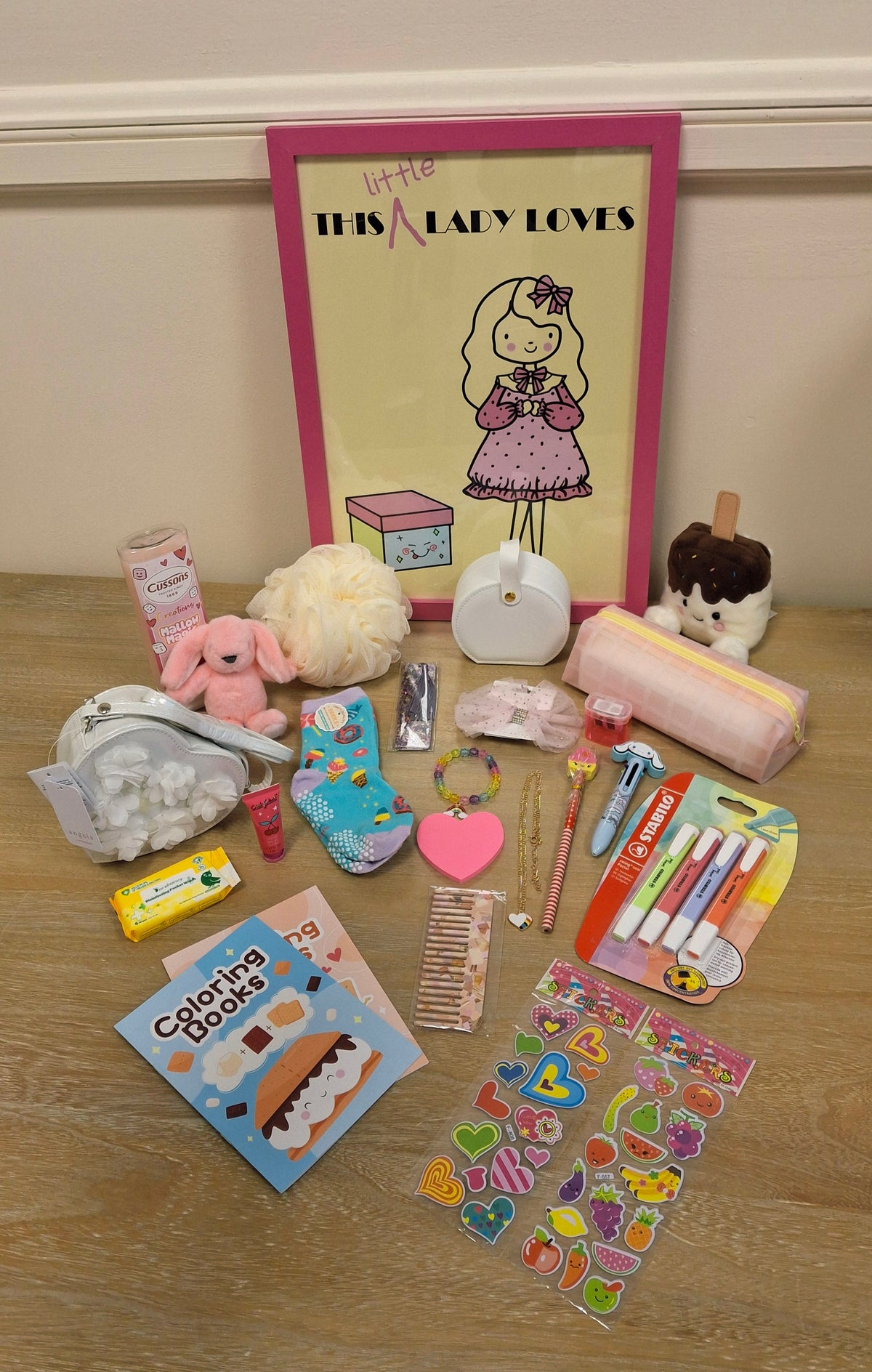 A curated collection of a handbag, pastel stationery and cute accessories.